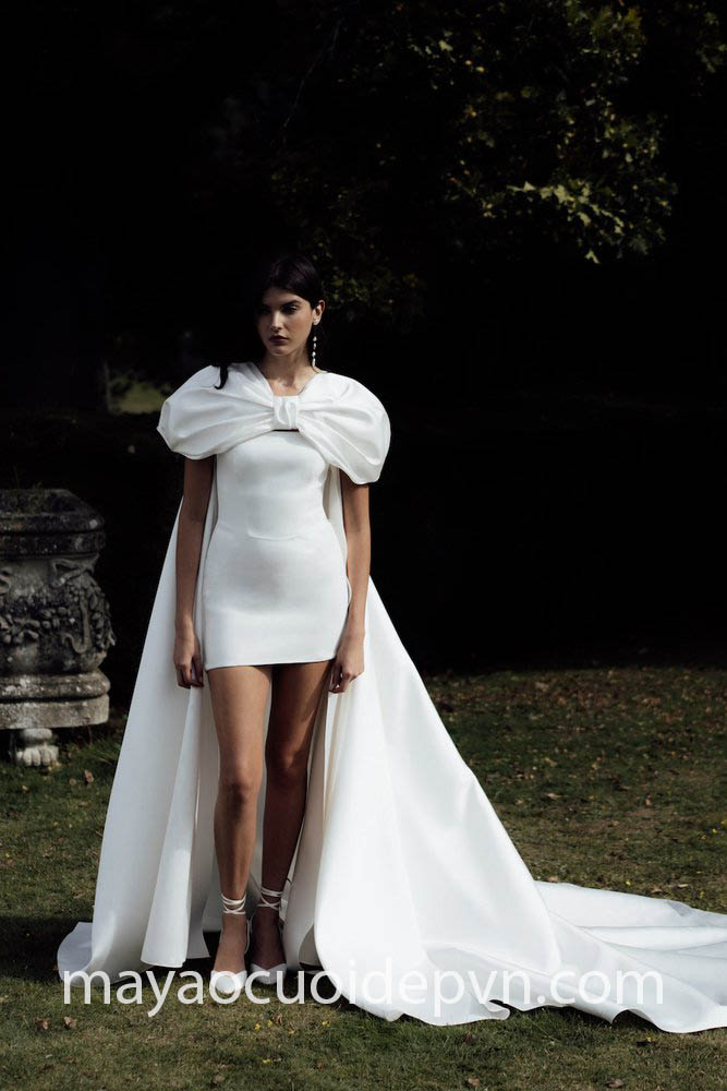 short wedding dress pairs with dramatic cape